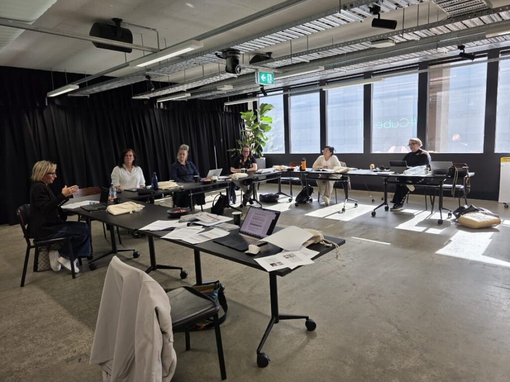 A small group working together at tables during the chAInge workshop.