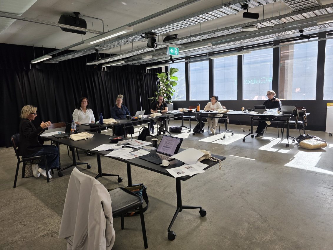 Workshop participants at cabaret tables during the Private AI Lab